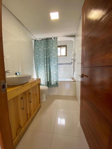 a bathroom with a sink and a toilet at Comfortable modular home in San Esteban