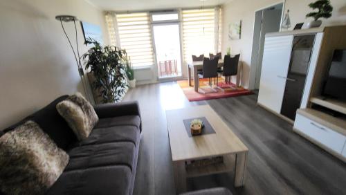 a living room with a couch and a table at "Sunny" in Burgtiefe auf Fehmarn 
