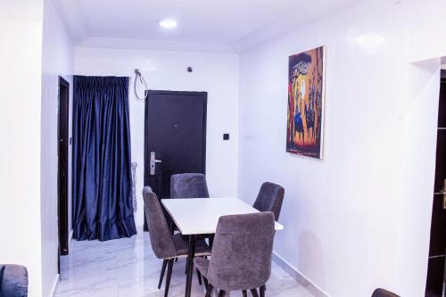 a dining room with a table and chairs at Afstar Apartments in Lagos