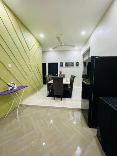 a living room with a table and a dining room at Ara Twin Homestay MelorKotaBharu 