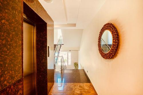 a hallway with a mirror on the wall at Hotel Classic Hills Bhagsunag Luxury Stay #Best Hotel in Mcleodganj #Mountain View Balcony Rooms #Spacious Parking #Prime Location in Dharamshala #Near Bhagsunag Waterfall #Top Selling Property in Mcleodganj in Dharmsala