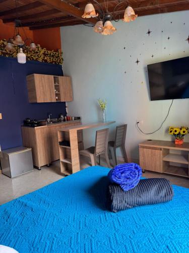 a living room with a large blue rug on the floor at Comfortable Apartment with a Starry Night Theme in Guatapé