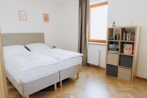 a bedroom with a bed and a book shelf at FamilyVilla, new 4 Luxury Big Apartments, parking in Prague