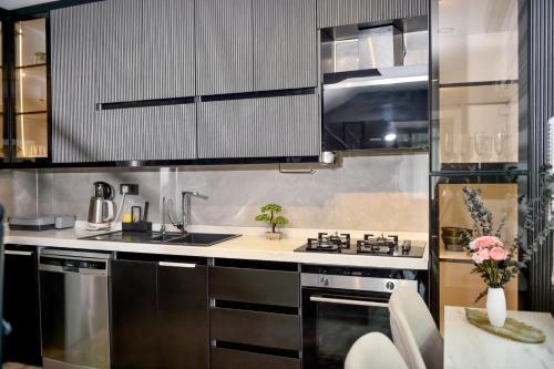 a kitchen with stainless steel appliances and a table at Villa L Olivia 2 in Belek