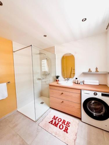 a bathroom with a washing machine and a sink at Casa Soleil Vibrant Caribbean Hideaway, Perfect for families & friends in Cul de Sac
