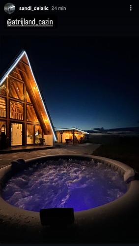 a hot tub in front of a building at night at Atrijland Cazin in Cazin