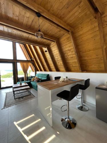 a kitchen with a table and chairs in a room at Atrijland Cazin in Cazin