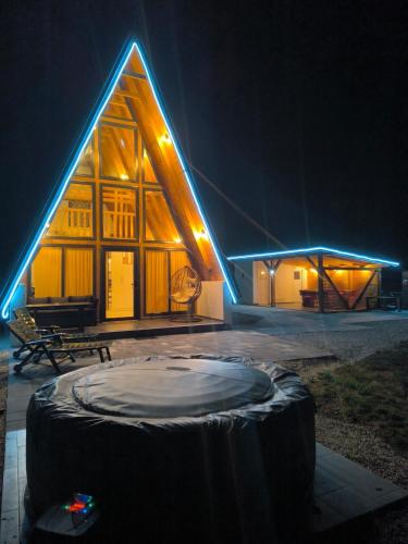 a large wooden building with a large mattress in front of it at Atrijland Cazin in Cazin