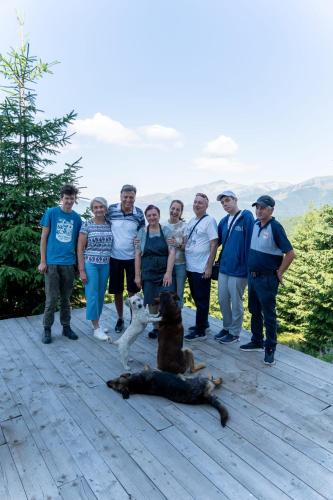 a group of people and a dog on a deck at Rusticanna RESTAURANT & SPA in Ranca