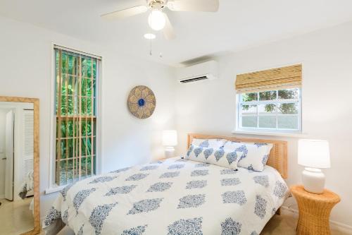 a bedroom with a bed and a clock on the wall at Coastal Getaway minutes from Siesta Key Beach in Sarasota