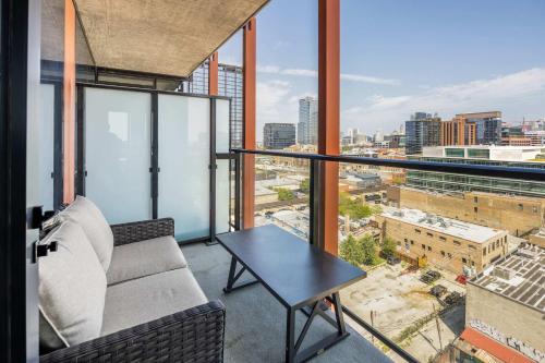a balcony with a table and a view of a city at Bright & Modern 2BR Perfect City Escape in Chicago