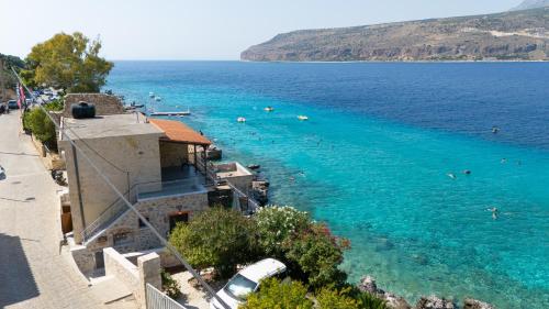 a view of a beach with people swimming in the water at Limeni koilakos Suite in Limeni