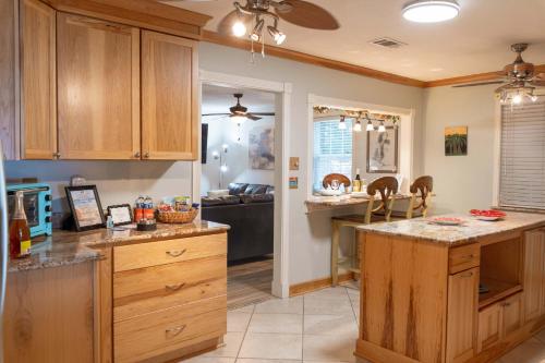 a kitchen with wooden cabinets and a counter top at Jan's Oasis Family Retreat Pool Bar Games & Fun in Pensacola