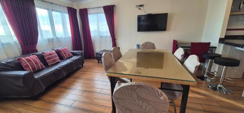 a living room with a table and a couch at Hogar Doña Gloria in Iquique