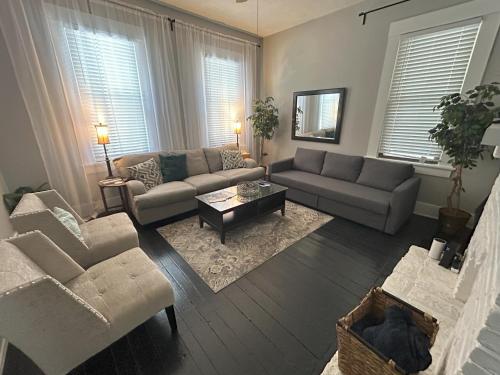 a living room with two couches and a coffee table at Riverside Hideaway - Brand New Deck! in Cincinnati