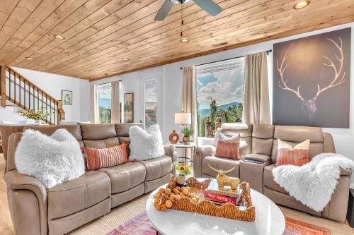 a living room with a couch and a table at Family Chalet With Rooftop Theater GameRoom Mins to DT in Gatlinburg