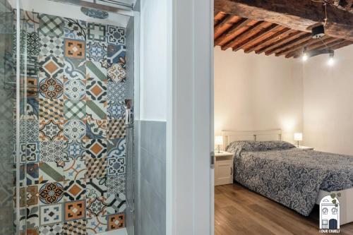a bedroom with a shower and a bed in a room at I due Ciueli in Pescia