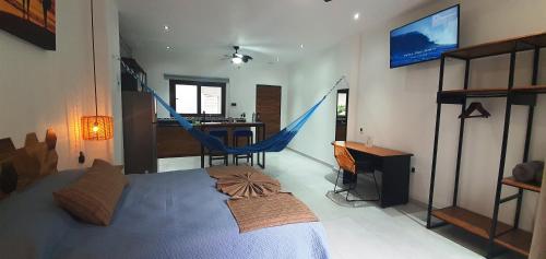 a bedroom with a bed and a hammock in it at Makawe in Sayulita