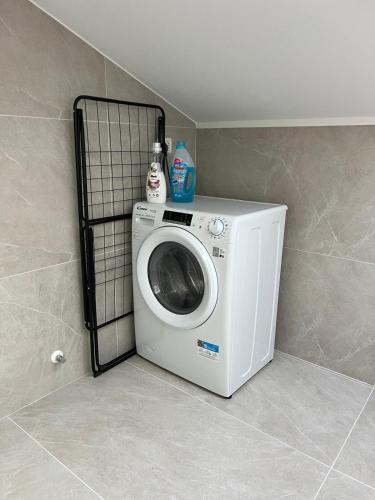 a washing machine in a corner of a room at Charming Alpine Apartment with Sauna in Kobarid