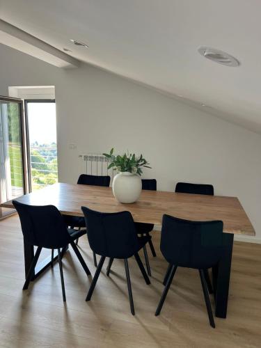 a dining room with a wooden table and chairs at Charming Alpine Apartment with Sauna in Kobarid