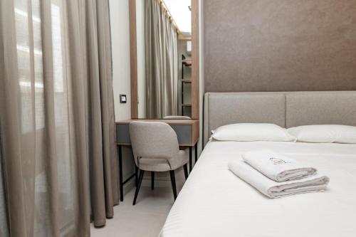 a hotel room with two beds and a mirror at Sienna Apartments in Shëngjin