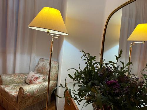a room with a chair and a lamp and a plant at Luxury Relax Apartment near Venice Station in Venice