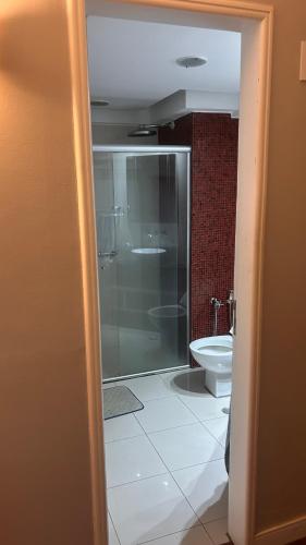 a bathroom with a glass shower and a toilet at Flat em hotel de luxo em Goiânia in Goiânia