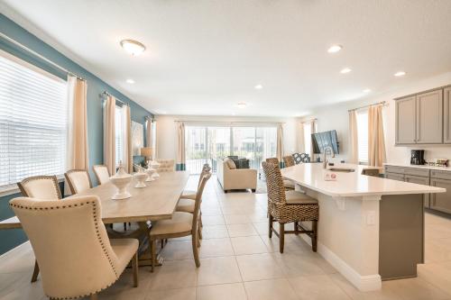 a kitchen and dining room with a table and chairs at Cozy Home With Private Pool, Air Hockey Table Near Disney With Waterpark & Resort Access At Encore Resort - 7702Gr in Kissimmee