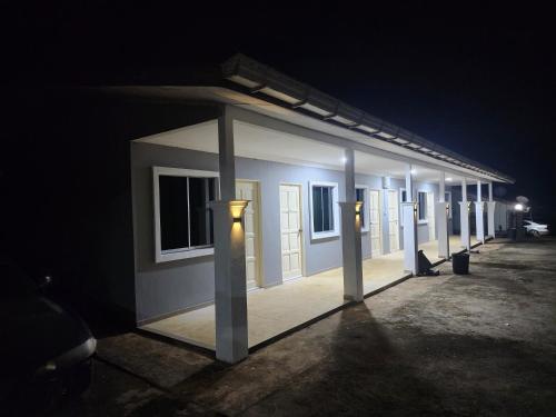 a row of stalls in a parking lot at night at Nagaya Peak Lodge in Ranau