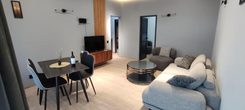 a living room with a couch and a table at BOND HOUSE Dilijan in Dilijan
