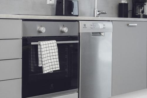 a kitchen with an oven with a towel on it at Pramea Apartments Aallonharja 4 in Jyväskylä
