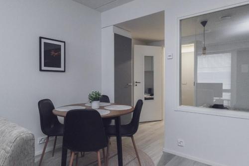 a dining room with a table and chairs at Pramea Apartments Aallonharja 4 in Jyväskylä