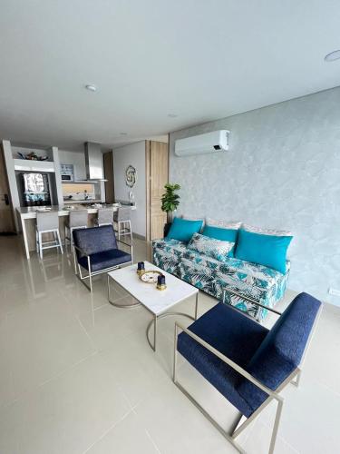 a living room with a couch and a table at Reserva Del Mar Apartamentos in Gaira