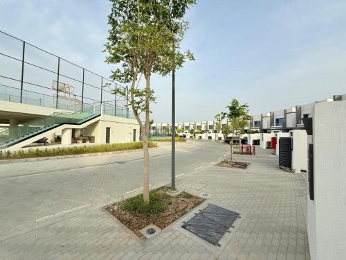 a tree on a sidewalk next to a building at Lux 3BR Villa, Sea Views & Pool in Sharm