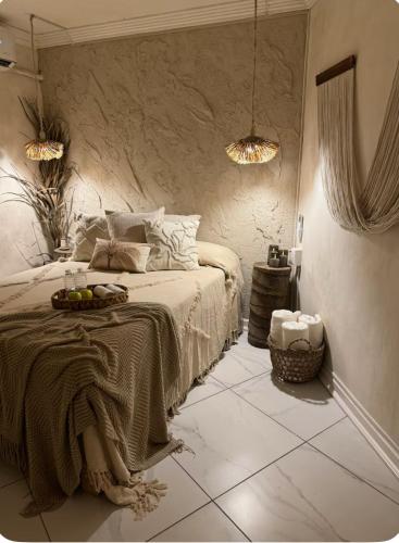 a bedroom with a bed with a table on it at Departamento en Club Santiago - Camina a la playa! in Manzanillo