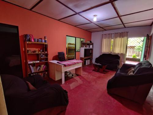 a living room with a couch and a desk at Tingo María Family Romero in Las Palmas