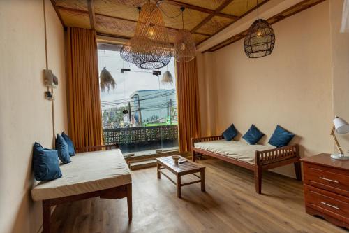 a living room with a couch and a window at Land of Joy in Ahangama