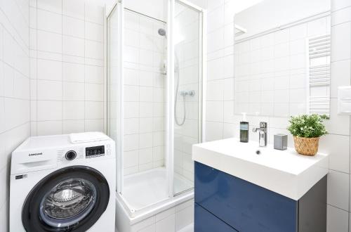 a bathroom with a washing machine and a sink at Graz 1464, Old City Center Apartments in Graz