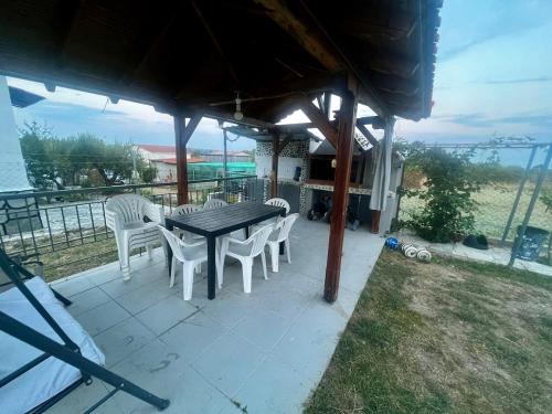 a table and chairs sitting under a gazebo at pRETTy home in Vergia