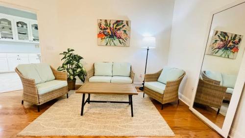 a living room with two chairs and a table at Spacious King Suite Home With Serene Patio in Hattiesburg