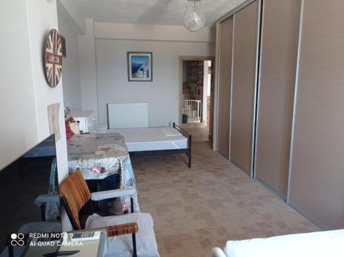 a room with a table and a bed in it at Angelikis Shared Home in Pírgos