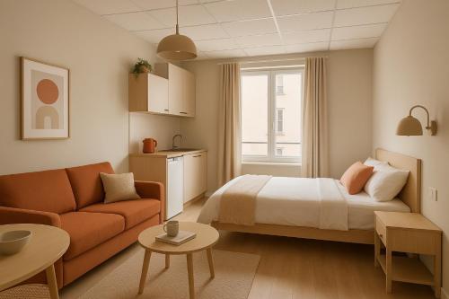 a hotel room with a bed and a couch at BEAUTY SAINT PAUL in Paris