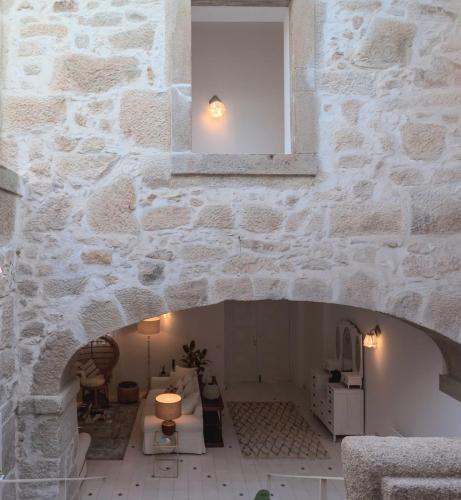 a room with a stone wall with a window at Quinta de Sá in Vila Nova de Gaia