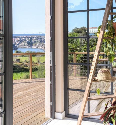 a ladder on a porch with a view of a deck at Quinta de Sá in Vila Nova de Gaia