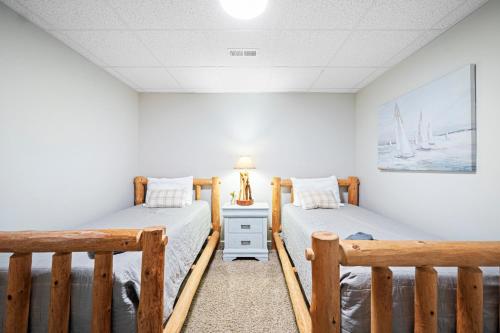 two beds in a room with white walls at Kentucky Lake Retreat in Dover