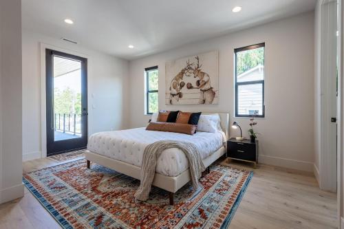 a bedroom with a white bed and a rug at Downtown Luxury Villa Hot Tub Walk To Lake in Coeur d'Alene