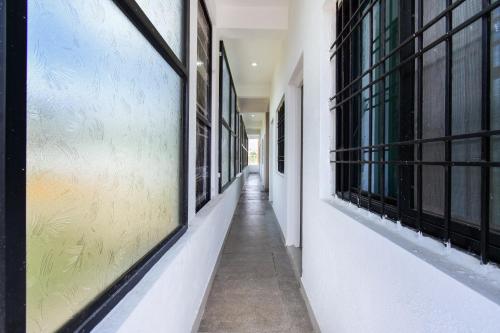 an empty corridor of a building with windows at Hotel O Everest Inn in Chikalthān