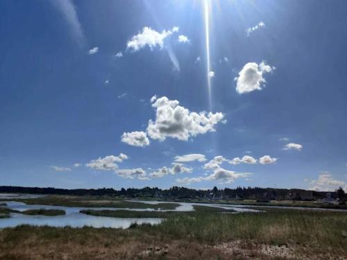 a view of a river with the sun in the sky at Luxury Retreat by Bonnerup - By Traum Ferienwohnungen in Glesborg