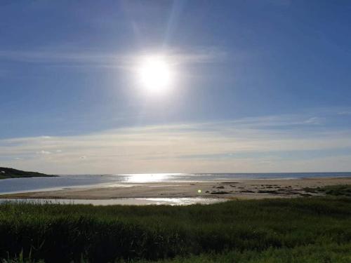 a view of a beach with the sun in the sky at Luxury Retreat by Bonnerup - By Traum Ferienwohnungen in Glesborg