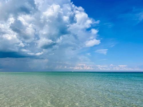 a view of the ocean under a cloudy sky at Luxury Retreat by Bonnerup - By Traum Ferienwohnungen in Glesborg